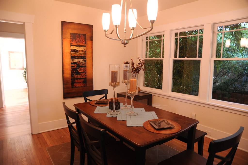 Light pours in from a back bedroom, into the dining room, table, lamp, art, candles, chairs, staged house, U District, Seattle, Washington, USA
